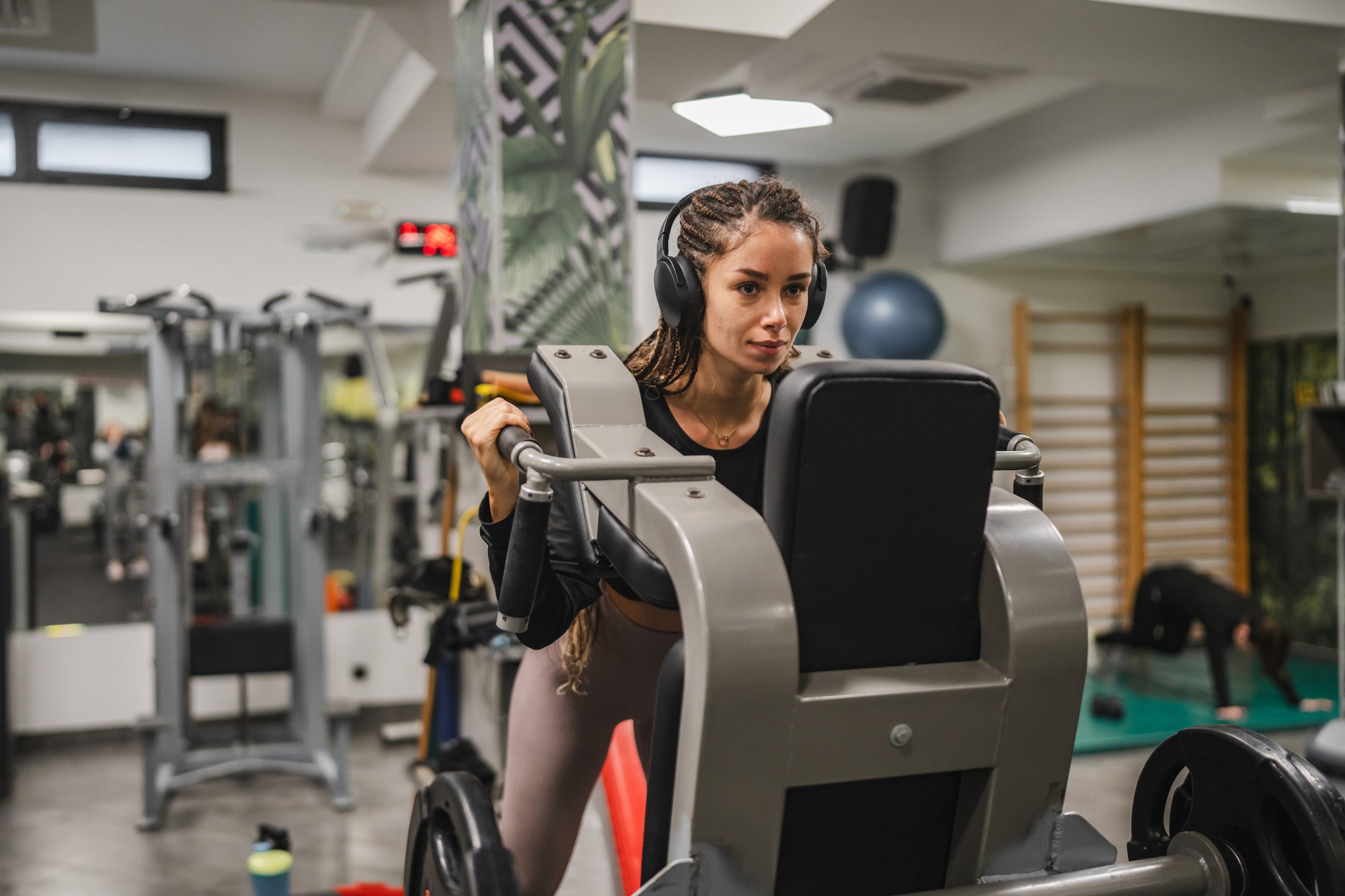 Woman using a weight machine in a gym