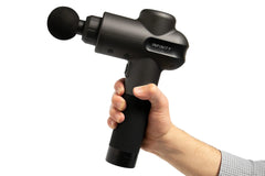 PR Pro Endurance Percussion Massage Device in color black being held by the user on a white background