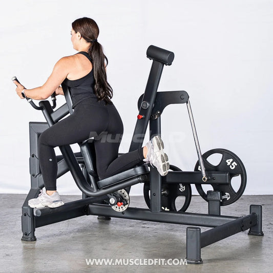 Female athlete using glute swing machine side angle view from backside of machine