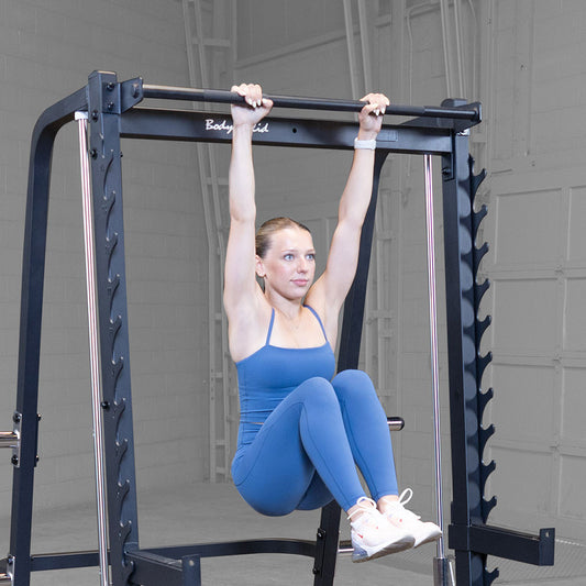 Smith Machine showing pull up bar in use by athlete