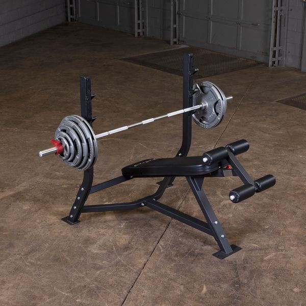 Olympic Decline Bench|Bench in use|Leg hold down adjustment|Bench loaded with weights