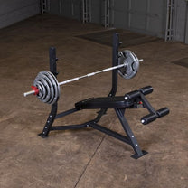 Olympic Decline Bench|Bench in use|Leg hold down adjustment|Bench loaded with weights