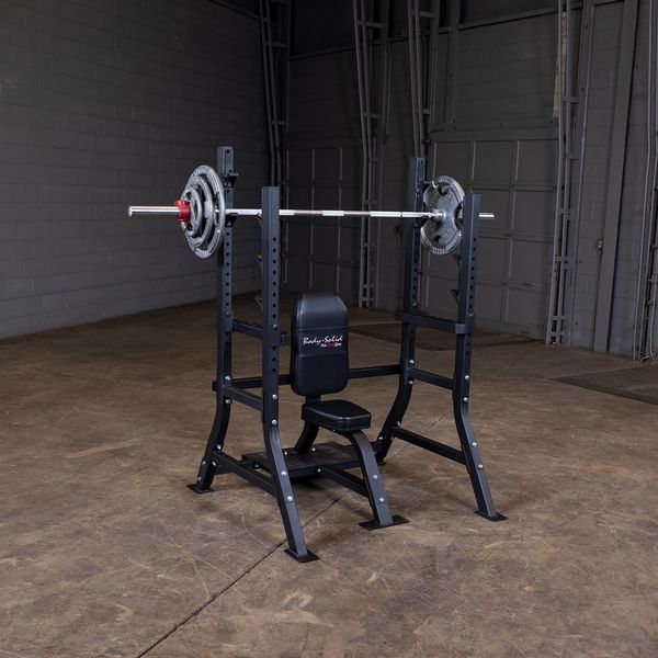 Olympic Shoulder Press Bench|Bench loaded with weights|In use|Safety crash bars|Seat back rest|Spotter Platform