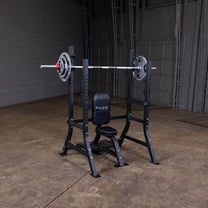 Olympic Shoulder Press Bench|Bench loaded with weights|In use|Safety crash bars|Seat back rest|Spotter Platform