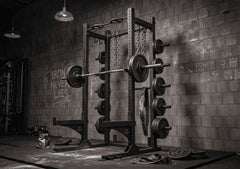 Half Rack shown in gym withg optional weight plates, bar, and chains