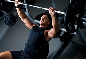 man lifting heavy barbell weights