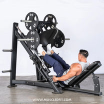 Person using the leg press machine with focus on calf raises