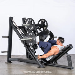 Athlete using the leg press machine in a gym setting with a white background