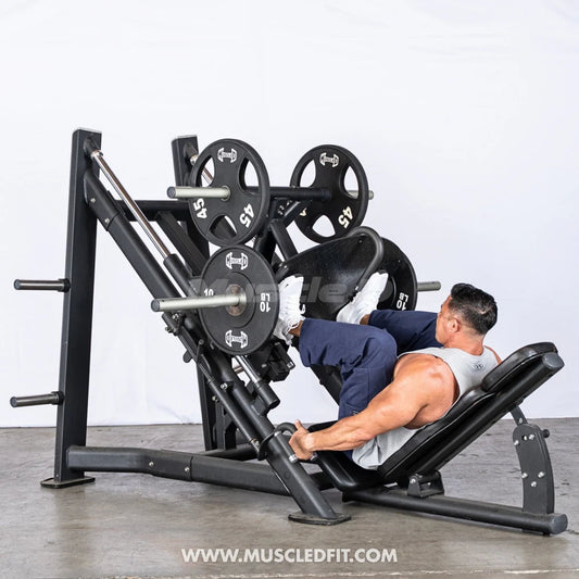 Athlete using the leg press machine in a gym setting with a white background
