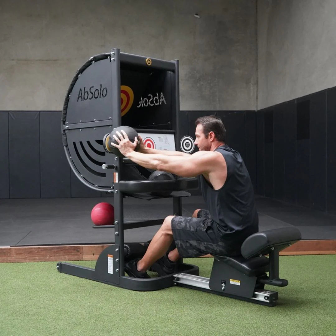Machine in use by athlete shown touching ball to left eye level target
