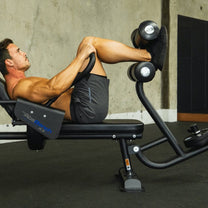 Athlete using bench shown from the side in crunch position