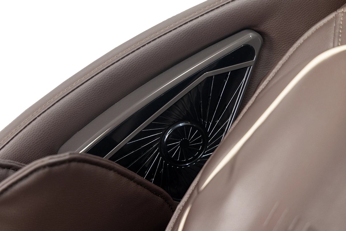 close up on integrated speaker located next to the chair headrest