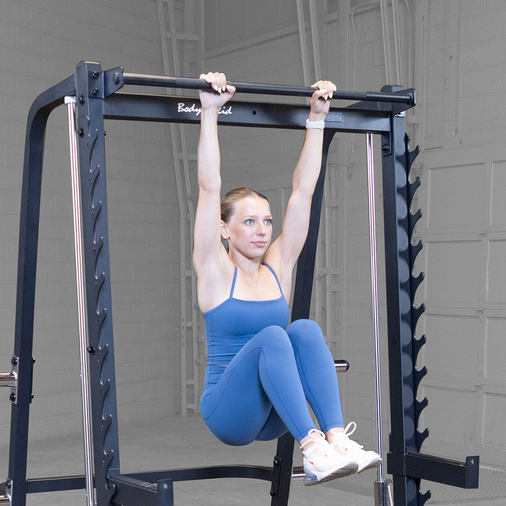 Smith Machine showing pull up bar in use by athlete