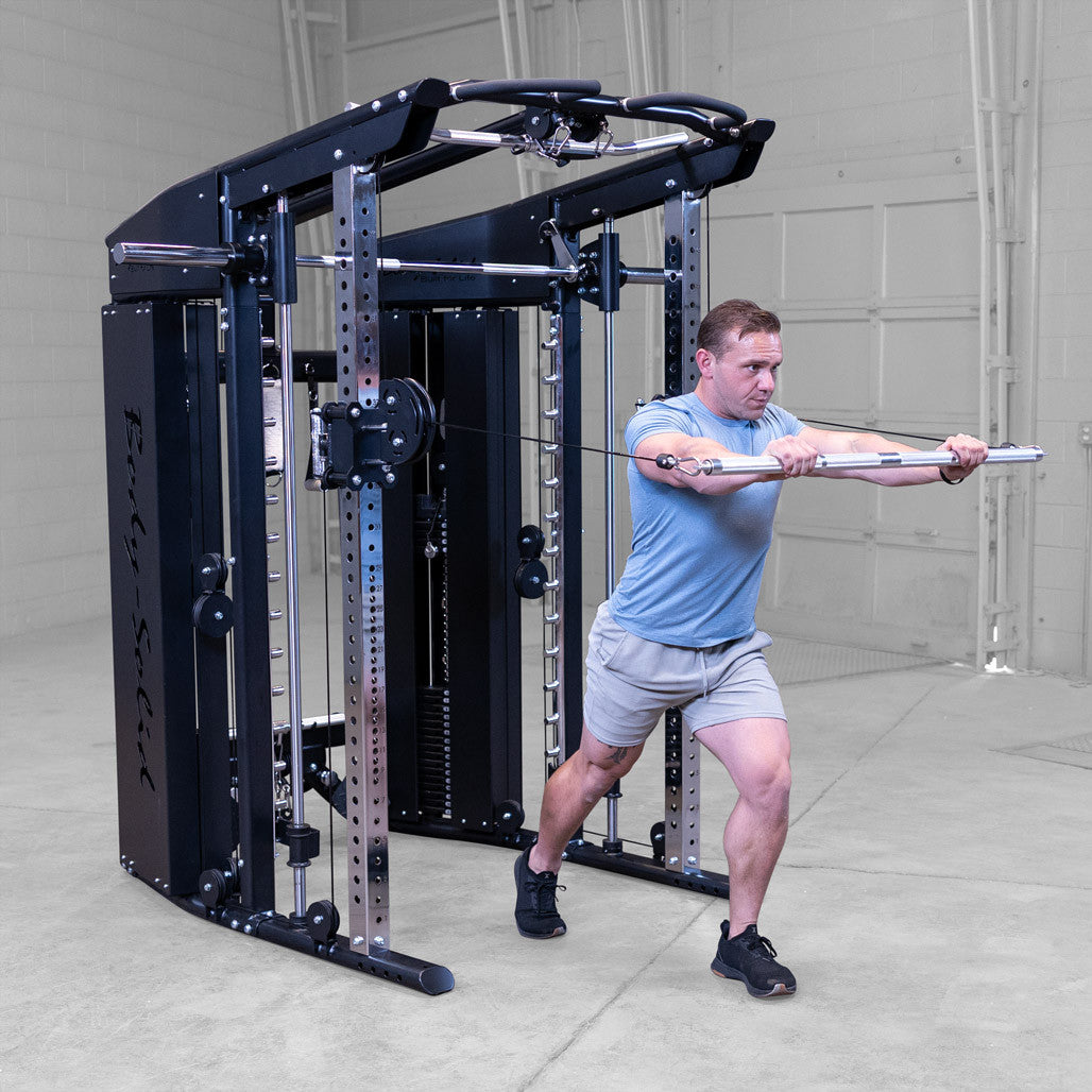 Male athlete performing standing bar chest press exercise using fuctional trainer component with included straight bar