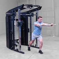 Male athlete performing standing bar chest press exercise using fuctional trainer component with included straight bar