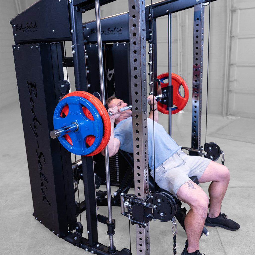 Male athlete performing incline chest press exercise using smith componenet