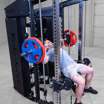 Male athlete performing incline chest press exercise using smith componenet