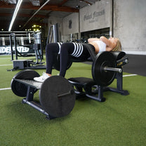 Athlete using machine - angle view of the finish (hips extended) position