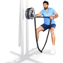 Athlete using the rope pulling drum in mid body position on a power rack