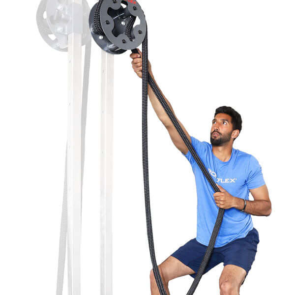 Athlete using the rope pulling drum in high position on a power rack