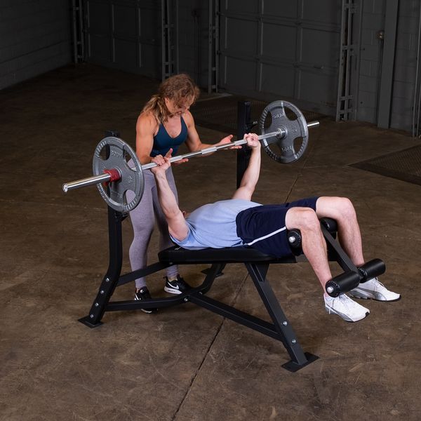 Olympic Decline Bench|Bench in use|Leg hold down adjustment|Bench loaded with weights