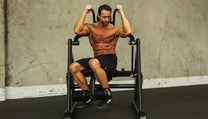 Athlete using machine showing obliques crunch exercise