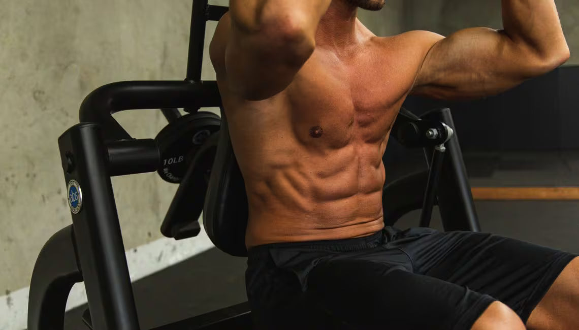 Closeup at althetes abs doing ab crunches on the machine