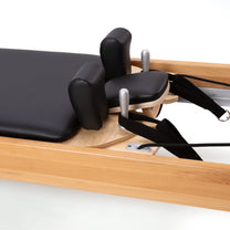 Cloeup of headrest on Refomer shown in beechwood material 