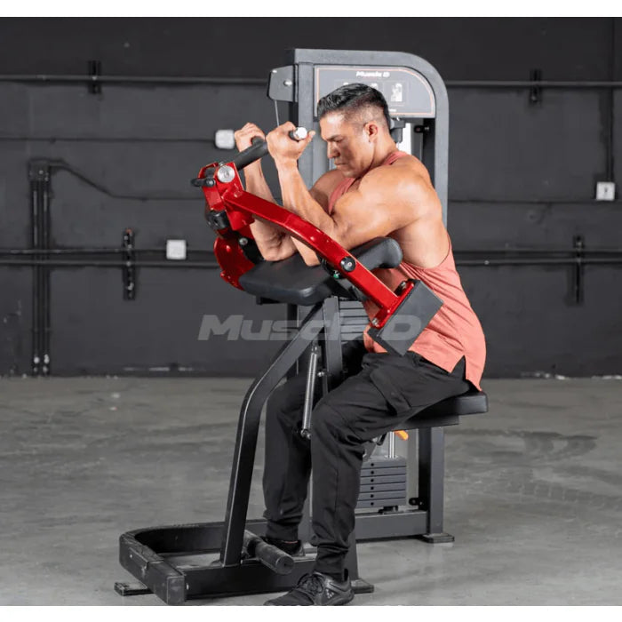 Athlete using biceps curl machine in end (contraction) position