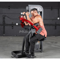 Athlete using biceps curl machine in end (contraction) position