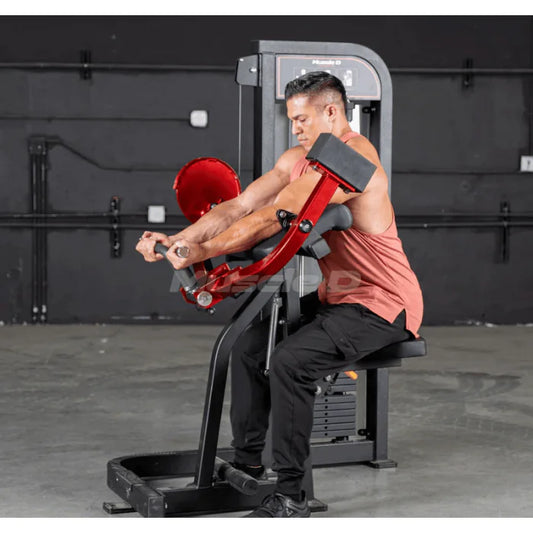 Athlete using biceps curl machine in start position