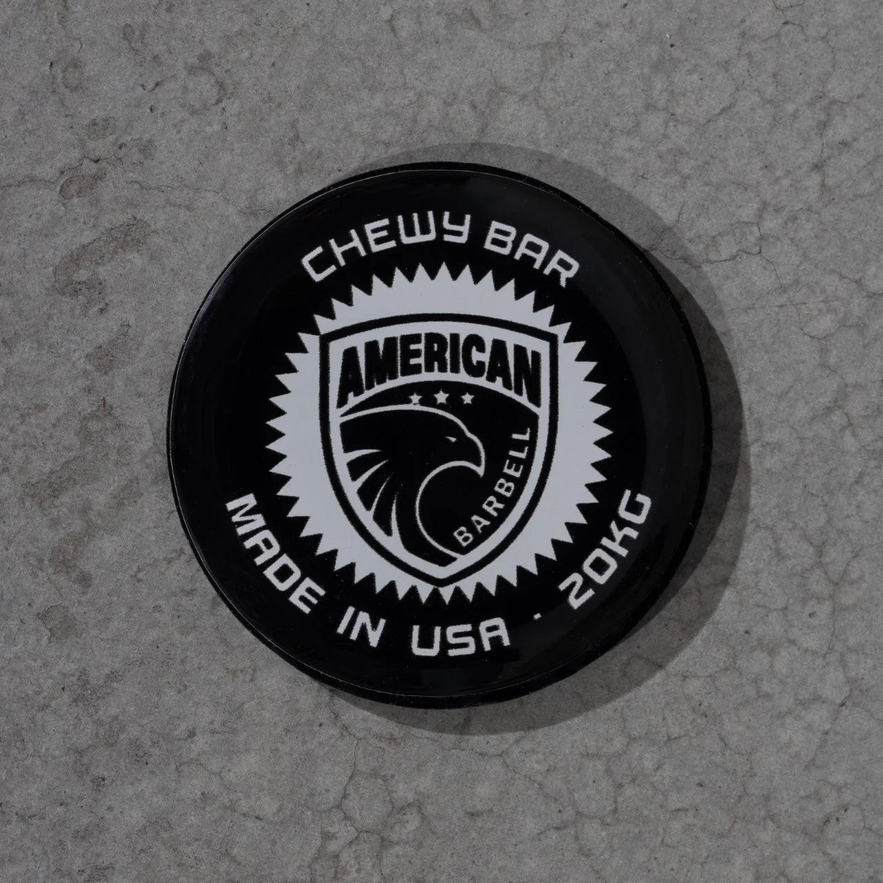 Closup of logo displaying American Barbell  logo and Chewy Bar text