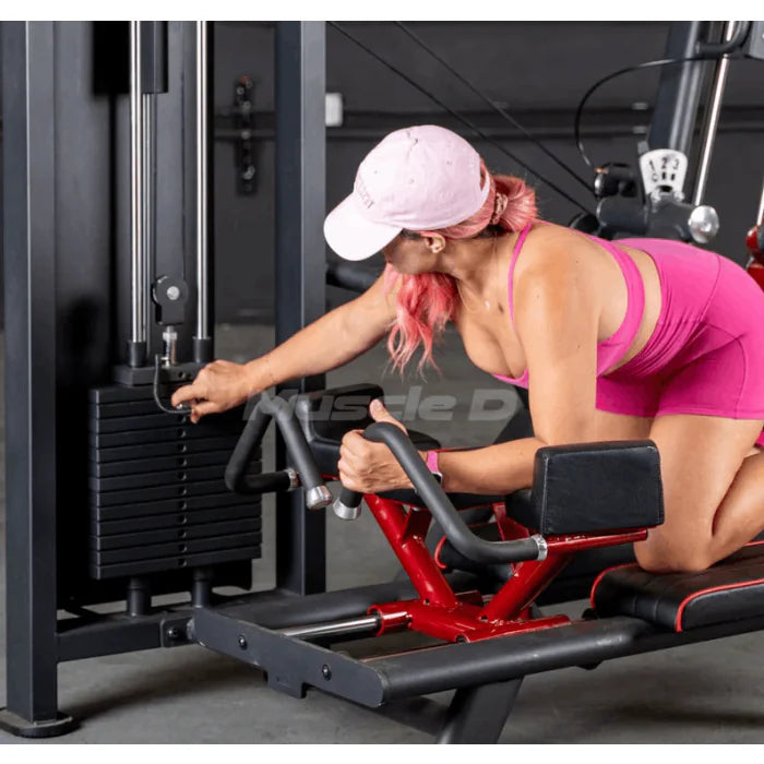 close up of woman using machine showing weight stack and grip handles