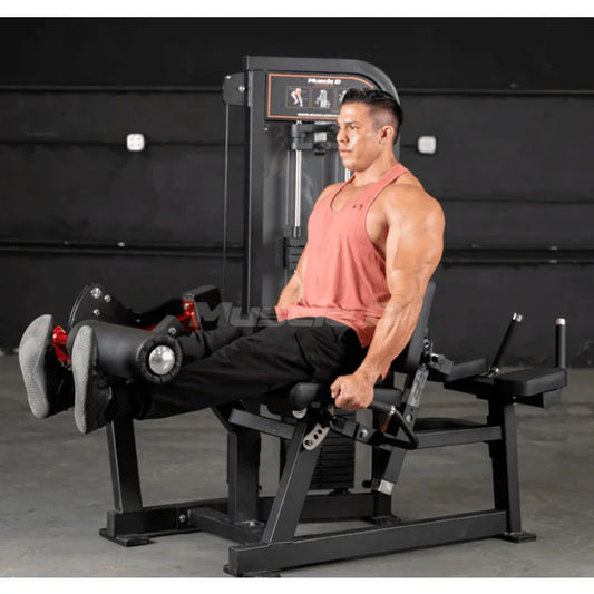 man doing seated leg extensions