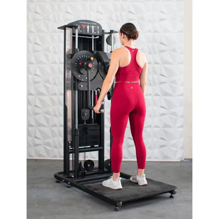 Athlete shown using machine for standing lateral raises