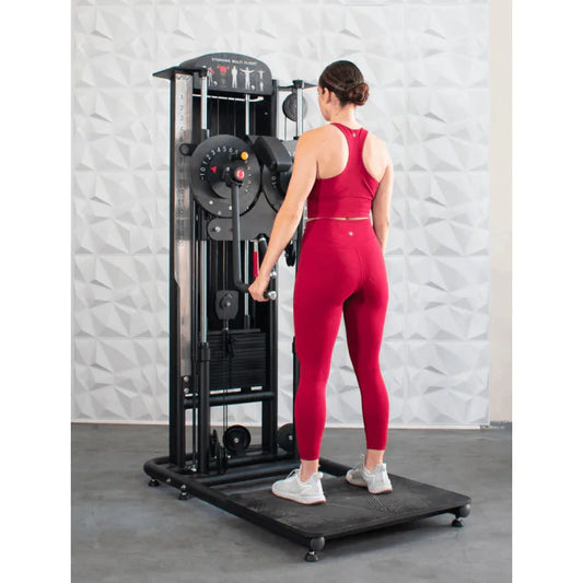 Athlete shown using machine for standing lateral raises