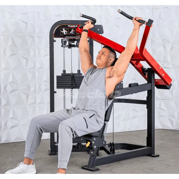 Athlete using should press machine in end/extend position