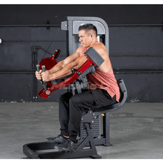 Athliete using machine shown in triceps extension positiion
